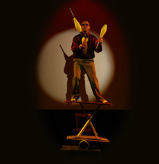 Kim Potter as Vinyl Burns juggles clubs on the rola bola ironing board 